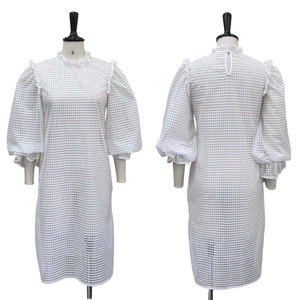 Front and back view of white hollow-out dress with puff sleeves and stand collar detail