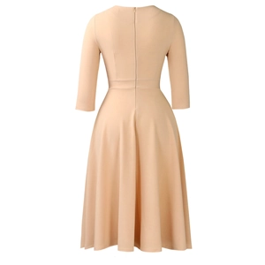 Detail view of the back zipper and high-waist tailoring on this beige A-line dress