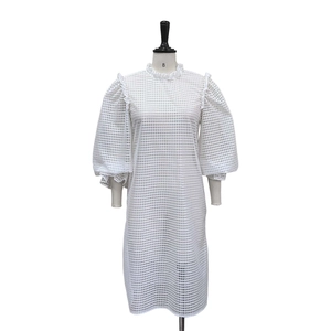 Detail of white hollow grid fabric with puff sleeves on a two-piece midi dress