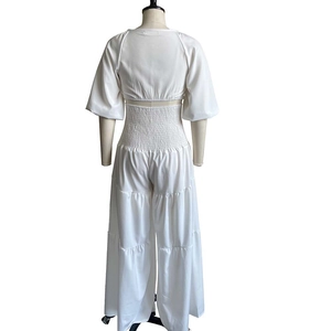 Dettaglio del completo bianco a due pezzi con vita elastica arricciata e pantaloni larghi