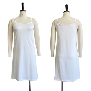 Front and back view of a white slip dress with thin straps and smooth elastic fabric