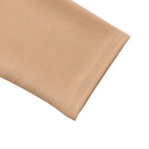 Close-up of the sleeve cuff with double-needle stitching on nude knit fabric