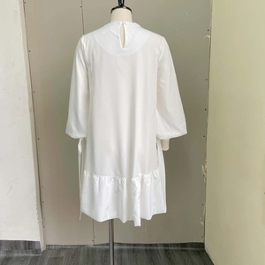 Detail of the white long sleeve dress with puff sleeves and back cutout design