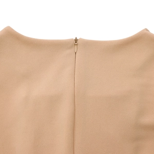 Detailed macro view of invisible back zipper closure on beige textured fabric dress