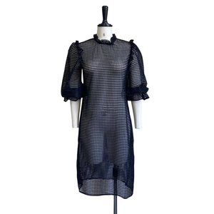 Detail of black hollow out mesh dress with puff sleeves and ruffled high neck collar