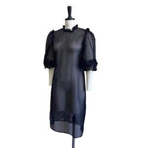 Close-up of navy blue mesh hollow-out fabric with puff sleeves and ruffle collar detail