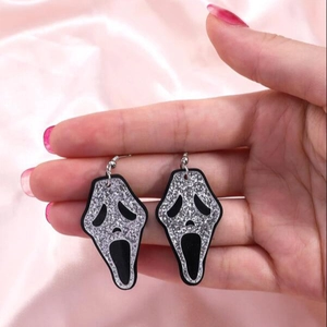 Close-up of Ghostface mask earrings with silver glitter finish for Halloween parties