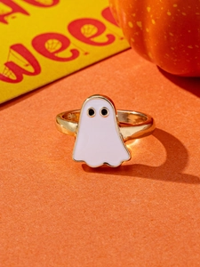 Detail of a minimalist gold Halloween ghost ring with white enamel on orange background