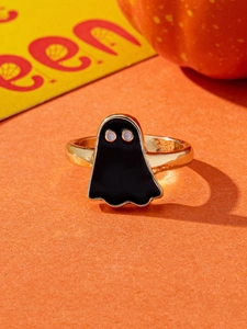 Detail of a gold ghost ring with black enamel finish for Halloween party jewelry