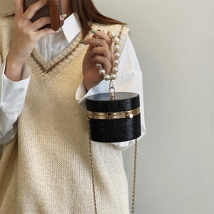 Elegant black cylindrical mini evening bag with sparkling crystals and pearl handle