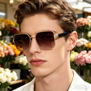 Close-up of stylish men's square metal-frame sunglasses with gradient brown lenses.