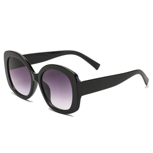 Retro black oversized sunglasses with purple gradient lenses and wide temples