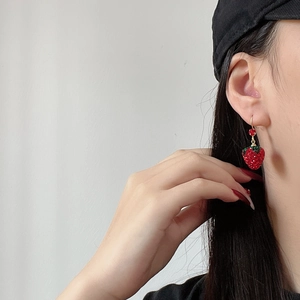 French vintage strawberry earrings with red rhinestones and gold hooks on model