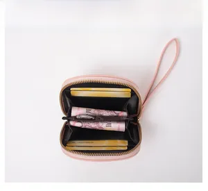 Detail view of pink cow wallet interior with card slots, bill pocket and golden zipper