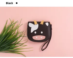 Detail of cartoon cow wallet in black PU leather with sturdy zipper and wrist strap