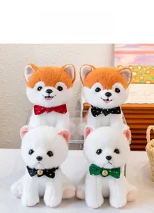Detailed view of four plush Shiba Inu puppies with bows displayed on an acrylic stand