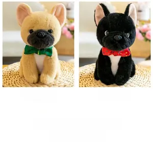 Detail of cute plush French Bulldog toys in yellow and black with polka dot bowties
