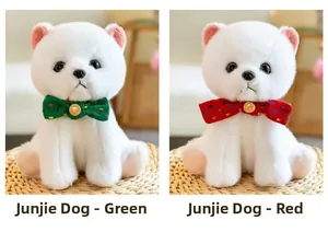 Close-up of white plush dogs with green and red polka dot bows on a woven mat