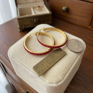 Close-up of 40mm 18k gold-plated hoop earrings with deep red rhinestones and measurements