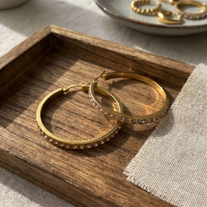 Detail of 40mm 18k gold-plated stainless steel hoop earrings with sparkling rhinestones