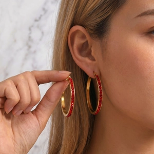 Chic 40mm 18k gold plated hoop earrings with red rhinestones on a female model