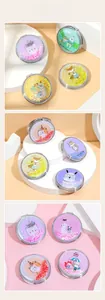 Detail of round folding makeup mirrors featuring cartoon animals and flowing glitter sand