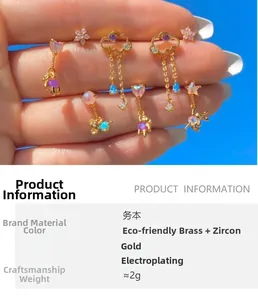 Detail view of 18K gold plated cloud tassel and zircon stud earrings under blue sky