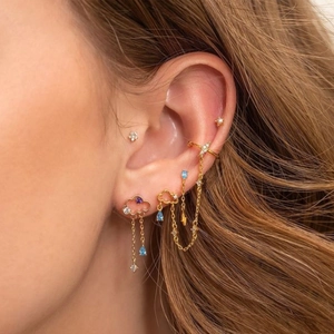 18K gold plated cloud tassel earrings with stars and blue gems on model