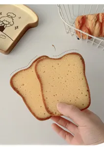 Close-up of toast shaped kitchen sponge showing realistic porous texture and soft foam