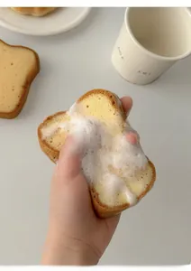 Close-up of toast-shaped sponge creating rich white foam for efficient kitchen cleaning