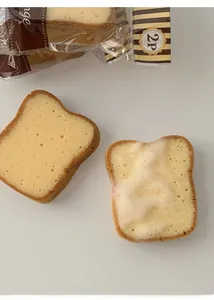 Detailed macro view of toast-shaped dishwashing sponges with soapy foam and 2P packaging