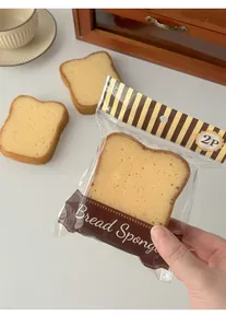 Detail view of two pieces of toast-shaped cleaning sponges with realistic bread texture