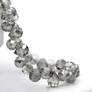 Macro shot of smoky grey faceted teardrop crystal beads with polished light-reflecting surfaces