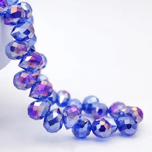 Macro shot showing detail of dark blue faceted teardrop crystal beads with sparkle