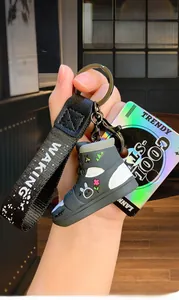 Detail of trendy graffiti sneaker keychain with fabric strap and colorful graphics
