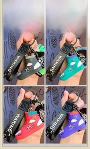 Detail showing four colorful silicone high-top sneaker keychains with cute rabbit patterns