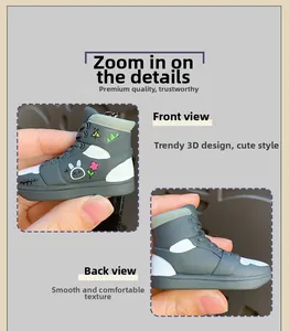 Detailed front and back view of cartoon sneaker keychain with graffiti flower patterns