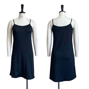 Front and back detail of minimalist black slip dress with spaghetti straps and smooth texture