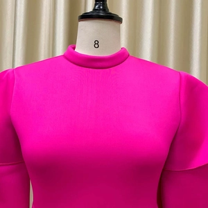 Detail view of the rose red high neck dress showing ruffled layered sleeve craftsmanship