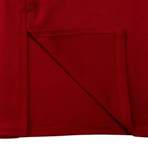 Détail de la robe en maille rouge foncé montrant la double couture et l'ourlet fendu latéral