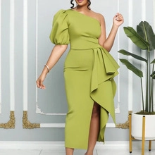 Detail of elegant one-shoulder puff sleeve dress with waist ruffles and side slit