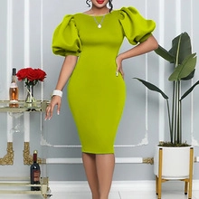 Detail of elegant lime green pencil dress featuring voluminous puff sleeves and slim fit cut