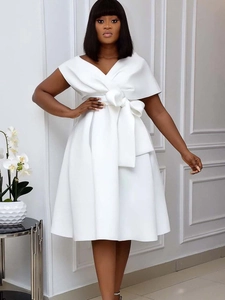 Elegant white V-neck dress with cape sleeves and a large waist bow for stylish women