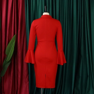 Rear view of red dress with flared sleeves, slim waist, and a back slit detail