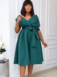 Elegant dark green V-neck A-line dress with a large bow belt and flattering flared hem