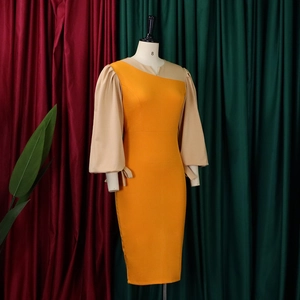 Detailed view of the yellow long sleeve dress with bow tie cuffs and asymmetric neckline