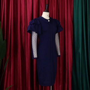 Close-up of navy pleated dress with mesh dot sleeves and elegant puff shoulder detail