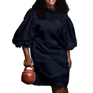 Detail of navy blue plaid mesh dress featuring puff sleeves and ruffled lace shoulders