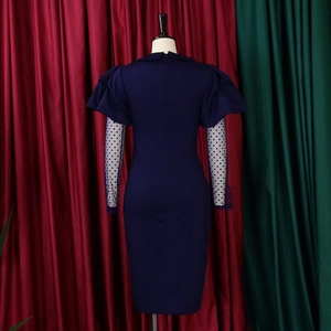 Detailed back view of a navy bodycon dress featuring white polka dot sheer mesh sleeves