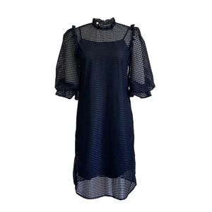 Close-up of mesh puff sleeves and ruffled high collar on a two-piece dress set
